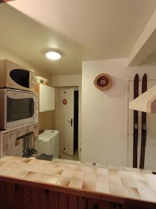 a kitchen with a counter top and a microwave at La grange d'Alexandre 6 personnes in Val Cenis +22 photos