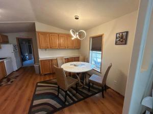 a kitchen with a table and chairs in a room at Private Home With Amazing Mountain Views-Two Bedroom and Two Bath in Saint Ignatius