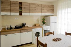 a kitchen with white cabinets and a table with a plate on it at Aurora Apartment in Berane