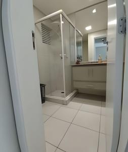 a bathroom with a shower and a sink at Terraços da Rainha AP1103 - Vista Espetacular - BC in Cabeçudas
