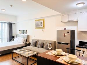 a living room with a couch and a table at Abreeza Place Cozy Condo in Davao City