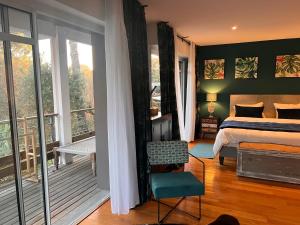 a bedroom with a bed and a balcony at Villa Sand Golf by Carlon Luxury Rentals in Seignosse +32 photos