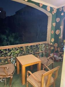 a patio with two chairs and a table and two chairs at Z m abartment hotel in Giza