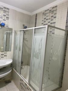 a bathroom with a shower and a sink at Z m abartment hotel in Giza