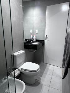 a bathroom with a toilet and a sink at Edificio Victoria in Encarnación