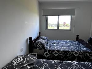 a bedroom with a bed and a window at Edificio Victoria in Encarnación