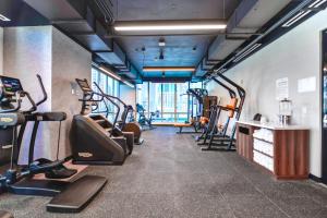 a gym with treadmills and elliptical machines at Great Miami Stay Steps from Bayside & the Beach in Miami