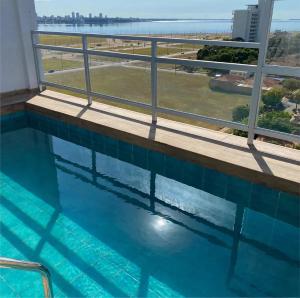 a swimming pool with a view of the ocean at Edificio Victoria in Encarnación