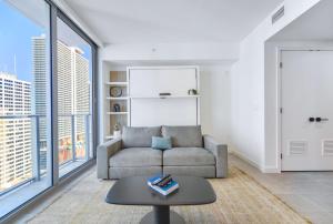 a living room with a couch and a table at Great Miami Stay Steps from Bayside & the Beach in Miami
