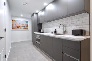a kitchen with a sink and a microwave at Great Miami Stay Steps from Bayside & the Beach in Miami