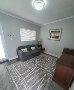 a living room with a couch and a piano at Bushman's Retreat in Bushmans River Village