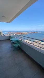 a balcony with a table and a view of the ocean at Departamento vista al mar cerca de todo in Iquique