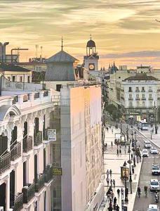 a view of a city with a clock tower at Piso Ático con Terraza y Jacuzzi con vistas a Sol en Madrid Centro in Madrid