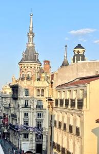 a tall building with a tower on top of it at Piso Ático con Terraza y Jacuzzi con vistas a Sol en Madrid Centro in Madrid