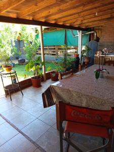 a patio with a table and some potted plants at Apart la hermosa in Puerto Iguazú