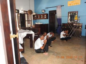 a group of men sitting on the floor in a room at Sirin Park Eco Tour in Horagampitiya