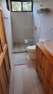 a bathroom with a toilet and a sink at Susanne's Bungalow de Casa Felicidad in Paquera +33 photos