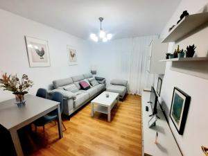 a living room with a couch and a table at Apartamento Obao in Ribadeo