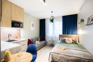 a small apartment with a bed and a kitchen at miniSTUDIOS URSUS by VAYA STAYS in Warsaw