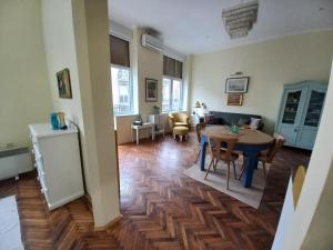 a living room with a table and a dining room at Ergzotic Apartments & Room in Sombor