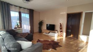 a living room with a couch and a coffee table at Naturblick in Baiersbronn