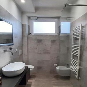 a bathroom with a sink and a toilet and a tub at Peter's Apartments in Pescara +14 photos