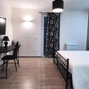 a bedroom with a bed and a table and a door at Peter's Apartments in Pescara