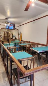 une salle à manger avec des tables bleues et des bancs en bois dans l'établissement Hosteria mundo tablas, à Mar del Plata