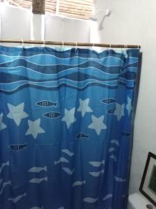a shower curtain with fish on it in a bathroom at Cabaña Buenos Aires in Palomino +25 photos