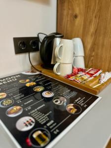 a counter top with a table with cups and a counter top at Skymoon Istanbul Airport Hotel in Arnavutköy
