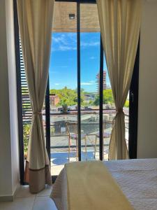 a bedroom with a bed and a large window at Studio for Tourism or Business Trip in Corrientes