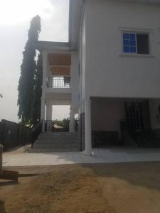 a large white building with a porch and stairs at R & S GUESTS House in Bota