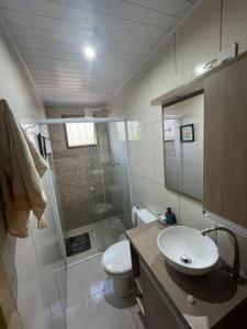 a bathroom with a shower and a toilet and a sink at Casa familiar rua 13 maio número 1639 in Rosário do Sul