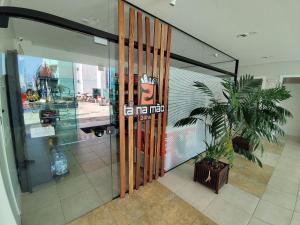 a store front door with a potted plant in front of it at Terraços da Rainha AP1103 - Vista Espetacular - BC in Cabeçudas +33 photos