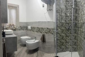 a bathroom with a toilet and a sink and a shower at Casa LUNA in San Giovanni Suergiu