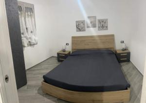 a bedroom with a bed and two night stands at Casa LUNA in San Giovanni Suergiu