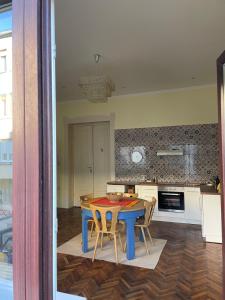 a kitchen with a blue table and chairs at Ergzotic Apartments & Room in Sombor