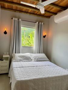 En eller flere senge i et værelse på Recanto do Paraíso