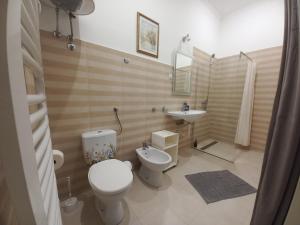 a bathroom with a toilet and a sink at Ergzotic Apartments & Room in Sombor