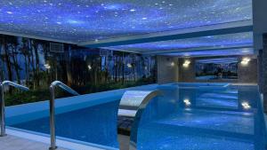 a hot tub in a building with a star ceiling at Plaża Resort Łeba & Wellness in Łeba