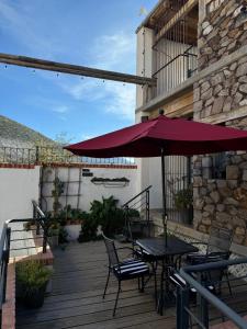 a patio with a table and chairs and an umbrella at CasaBlanca Hotel in Real de Catorce