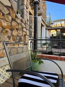 a chair on a porch with a stone wall at CasaBlanca Hotel in Real de Catorce