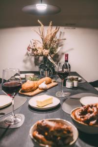 a table topped with plates of food and wine glasses at LIVALPIN Comfort in Garmisch-Partenkirchen