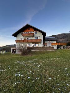 a large house with a field in front of it at Ferienhof Oberer Riesner in Tiefgraben