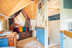 a room with a bed in a tiny house at Ophrys ha Melenig in Plouhinec +30 photos