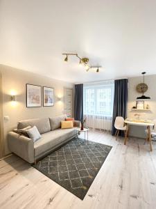 a living room with a couch and a table at City Center Apartment in Narva