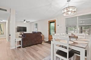 a living room with a dining table and a couch at Golfers beach bungalow in Myrtle Beach