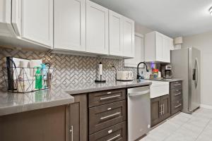 a kitchen with white cabinets and stainless steel appliances at Golfers beach bungalow in Myrtle Beach