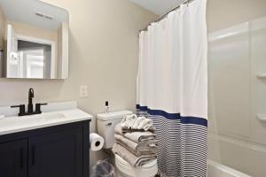 a bathroom with a toilet and a shower curtain at Golfers beach bungalow in Myrtle Beach +22 photos
