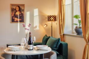 a table with two glasses and a bottle of wine at Residence S7 - Luxury living Apartment in Prešov